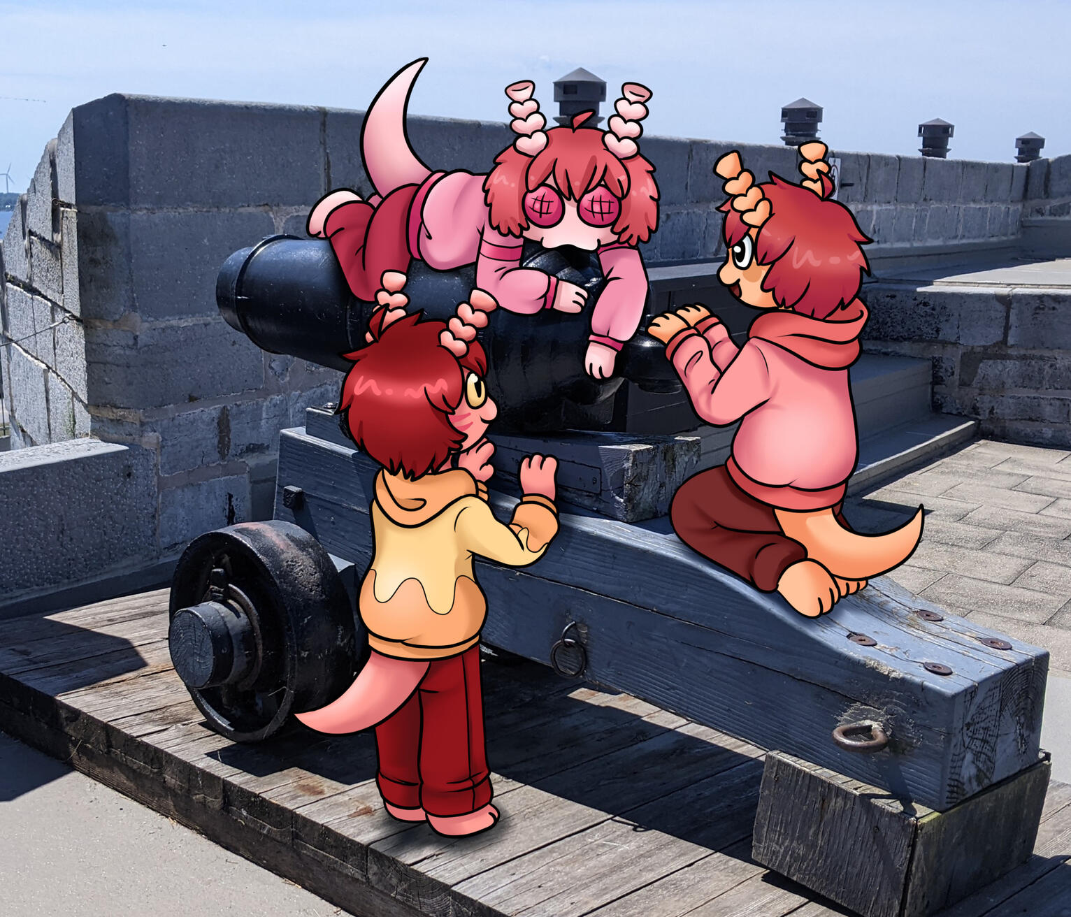 Three alien creatures drawn on a photo of a cannon